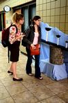 Sophomore music majors, Madelyn Carson and Kelsey McFarland, observe a work of art for the 3-D Design class.  - Photo by Anne Richoux