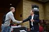 Michael Lewis, senior biology major, shakes hands with James Scruton, poet and head of the humanities division at Bethel College, after his poetry reading on campus. - Photo by Zac Calvert