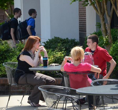 Erika King, enrollment counselor, talks with prospective students outside of Barefoots Joe on a beautiful Spring afternoon.