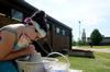 Megan Thompson, senior art major, throws pottery for ceramics class on a warm, sunny day.  - Photo by Anne Richoux