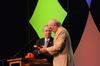 David S. Dockery, president of the university, presents keynote speaker Terry Bradshaw with a Holman Christian Standard Bible and a Union ballcap at the Roy L. White Legacy Golf & Gala. - Photo by Zac Calvert