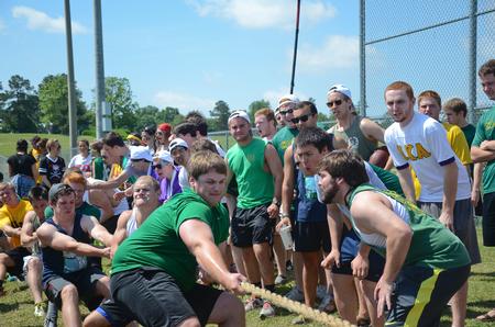 The men of Lambda Chi Alpha cheer on their fellow members as they participate in the rope pull during Greek Olympics.