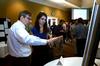 David Ward, professor of physics, talks with Caroline McConnell, junior engineering major, about her research poster during the Scholarship Symposium. - Photo by Anne Richoux