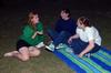 Art majors, Hannah Russell, Katie Williams, and Caitlyn Miller, laugh together while waiting for SAC's Movie on the Lawn, Sherlock Holmes 2, to begin. - Photo by Anne Richoux