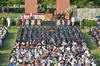 David S. Dockery, president of the university, welcomes graduates, employees, and guests to spring graduation in front of Miller Tower. - Photo by Morris Abernathy