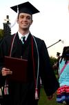 Andy Seaton, Christian studies graduate, joyfully walks back to his seat after receiving his diploma during  spring graduation.  - Photo by Anne Richoux