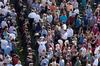Graduates make their way through a large crowd of friends and family during the processional for spring graduation.  - Photo by Kristi McMurry