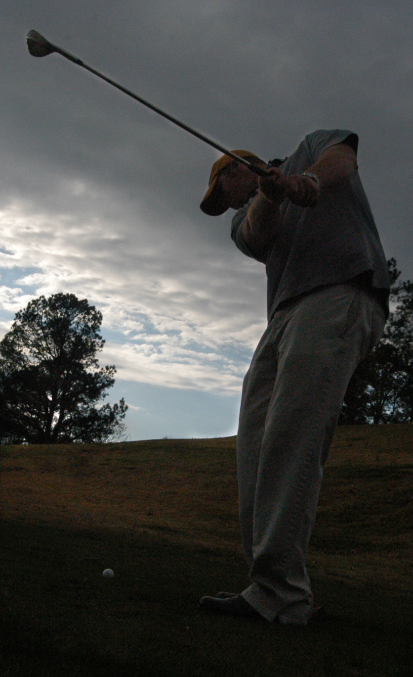 Freshman golfer Chase Whitby drives a ball on a cloudy day. - Photo by Jonathan Blair