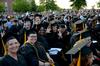 Graduates show excitement while celebrating their spring graduation.  - Photo by Ebbie Davis