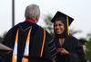 Keta Patel receives her doctor of pharmacy degree from David S. Dockery, president of the university, during spring graduation. - Photo by Jacob Moore