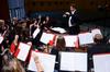 Michael Mann, visiting assistant professor of music, directs during a symphonic band concert.  - Photo by Ebbie Davis