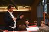 Michael Mann, visiting assistant professor of music, directs a symphonic band concert in the Savage Chapel. - Photo by Ebbie Davis