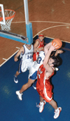 Ben Frederick (54) goes up for a basket in a Union win over Lambuth while teammate Zach Wiggs prepares to rebound. - Photo by Kristen Hiller