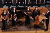 Members of the string quartet receive applause after their performance at the Spring Choral Concert. - Photo by Ebbie Davis
