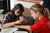 Kate Allen, senior art major, does henna tattoos for students in Residence Life's stress-free zone during finals week.  - Photo by Anne Richoux