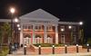 The new Hendersonville facility is illuminated by lamp light the evening before the dedication ceremony. - Photo by Morris Abernathy