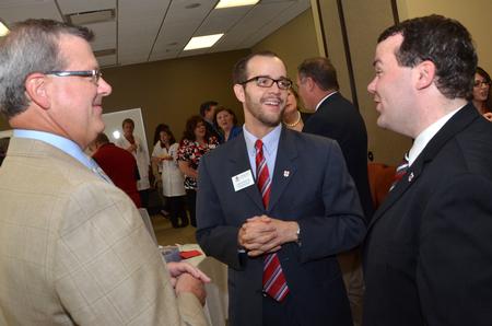 Norman Hill, chair of the university board of trustees, Landon Preston, director of donor relations, and Josh Clarke, director of alumni relations, chat together preceding the dedication ceremony of the new Hendersonville facility.