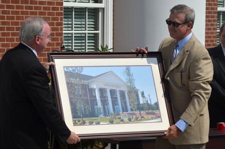David S. Dockery, president of the university, presents Norman Hill and the Board of Trustees with a framed photograph of the Hendersonville facility as a thank you for their support. 