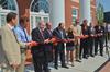 Vital members of the team that built the new Hendersonville facility, including Gary Carter, David S. Dockery, Jim and Janet Ayers, Norman Hill, Randy Davis, Scott Foster, Gene Fant, and two TLM representatives, cut the ribbon during the dedication ceremony. - Photo by Morris Abernathy