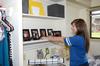 Danica Smithwick, freshman journalism major, straightens a photo in her new bedroom, after moving to Union from Marion, AR.  - Photo by Ebbie Davis