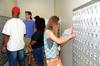 Elise Watkins(right), freshman public relations major, opens her new mailbox for the first time as a Union student during new student move-in day.  - Photo by Ebbie Davis
