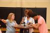 Kelly Rawls, junior sports medicine major, gives directions to Simone Cage, freshman marketing major, and his mother, Bobby, during new student move-in day.    - Photo by Zac Calvert