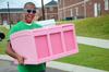 Jordan Timbs, senior physical education and health major, helps carry his LifeGroup member's dresser to her room during new student move-in day.  - Photo by Ebbie Davis