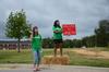 Madeleine Hemphill, psychology and business double major, and Abbie Perez, sophomore nursing major, greet new students at the Walker Road entrance during new student move-in day. - Photo by Zac Calvert