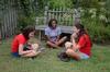 Liz Bankston, junior vocal performance major, Amber Buggs, freshman education major, and Karis Kontilis, freshman art and English double major, laugh together during the annual ice cream social at the home of the Dockerys.  - Photo by Anne Richoux