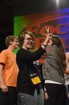 Krista Bradley, senior teaching English as a second language major, gives her focus group the "OK" sign before participating in a rock-paper-scissors tournament between focus leaders during the annual SAC game show. - Photo by Zac Calvert