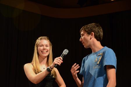 Megan Miller, senior social work major, holds the microphone for Michael Avery, freshman christian studies major, as he participates in the annual SAC game show.