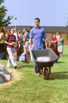 Sophomore Christian Studies major John Reed helps move a larger stone at the September 11 Service of Remembrance and Response. - Photo by Jim Veneman