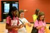 Holly Johnson, freshman business major, and other freshmen girls excitedly open their bid card envelopes to find out which sorority they will join on bid day. - Photo by Anne Richoux