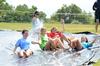 Members of Zeta Tau Alpha Leah Hamilton, junior family studies major, Hannah Richardson, freshman biology major, Kathlin White, sophomore elementary education major, and Mary Jo Stinson, freshman undecided major, enjoy a slip 'n slide on Panhellenic Bid Day.  - Photo by Anne Richoux