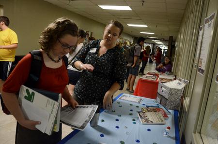 Jennifer Farroll (right), clinical coordinator for athletic training, talks to Abby Thigpen, freshman English major, about an external study trip during the the external study fair in Penick Academic Complex. 