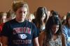 Morgan Roth, sophomore nursing major, and Alexis Pham, sophomore business administration major, join their fellow students in prayer while worshiping at chapel.  - Photo by Ebbie Davis