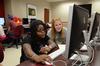 Treasure Hightower, senior digital media studies major, proofs a page for the Cardinal & Cream student newspaper with Brooklin Byrd, junior biology major. - Photo by Jacob Moore