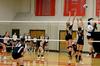 Kristin Cook, freshman psychology major, and Jami Humphries, junior media communications major, combine for a double block against the University of West Florida. - Photo by Anne Richoux