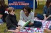 Amber Buggs, freshman elementary education major, reads a book to Caleb Brunet, son of Josh Brunet, at Union Night during Family Weekend. - Photo by Anne Richoux