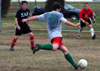 Junior Brandon Nelms takes a shot on goal against SAEs Grant Taylor and Jacob O'Brien during an intramural soccer game. - Photo by Jonathan Blair