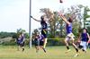 Aubrey Binkley, sophomore sports medicine major, and Matt Street, senior business administration major, jump for the football at an intramural game during Family Weekend. - Photo by Zac Calvert