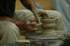 The hands of Chris Staley work on a piece during a ceramics workshop held on Union's campus. - Photo by Jonathan Blair