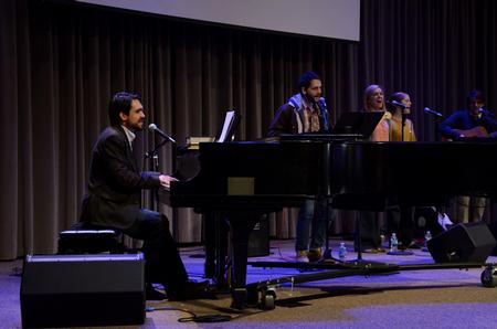 Cody Curtis, assistant residence director, leads worship music during the final chapel of Faith in Practice week. 