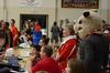 Lanese Dockery, first lady of the university, and Buster the Bulldog watch the festivities of Bulldog Madness, which was held in the Fred DeLay Gymnasium. - Photo by Jacob Moore