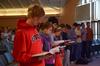 Students follow along as Larry York, pastor of Crossroads Baptist Church in Woodlands, Texas, reads the Scriptural account of Jesus healing the paralytic, found in Luke 5. - Photo by Jacob Moore