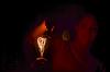 Students hold a magnet and light bulb close together during the Fire and Lights Show. - Photo by Zac Calvert