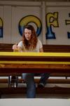 Natalie Schklar, senior social work major, paints tables in North Side High School's gym during Union's tenth annual Campus and Community Day. - Photo by Anne Richoux