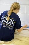 McKenzie Dorris, junior mathematics major, paints the trim in the youth room at Cornerstone Baptist Church. Dorris was joined by her LIFE group to work in the tenth annual Campus and Community Day.  - Photo by Ebbie Davis