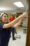 Laura Little, sophomore Christian ministry and missions major, rolls the youth room walls at Cornerstone Baptist Church during the tenth annual Campus and Community Day.  - Photo by Ebbie Davis