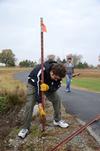 Lowell Van Ness, senior history major, works with the history department on the grounds of Parker's Crossroads Battlefield in Henderson County during Campus and Community Day. - Photo by Jacob Moore